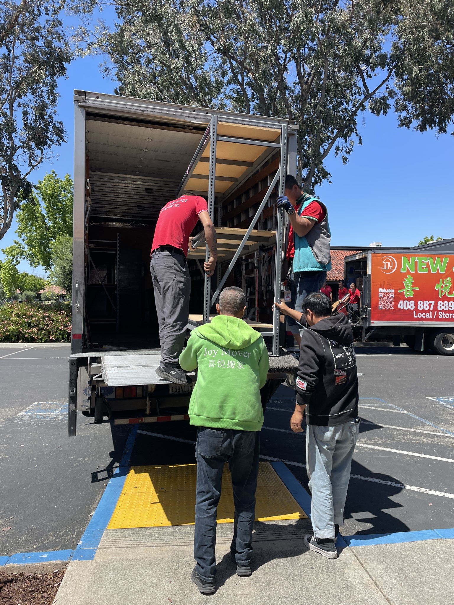 New Joy Moving movers loading furniture onto a moving truck